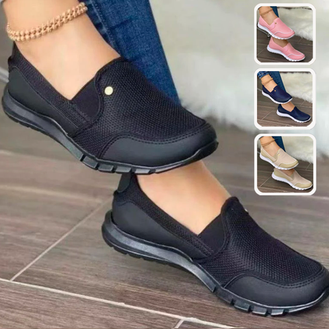 Black slip-on walking shoes for women, featuring breathable mesh design and cushioned soles. Available in multiple colors. Comfortable casual footwear.