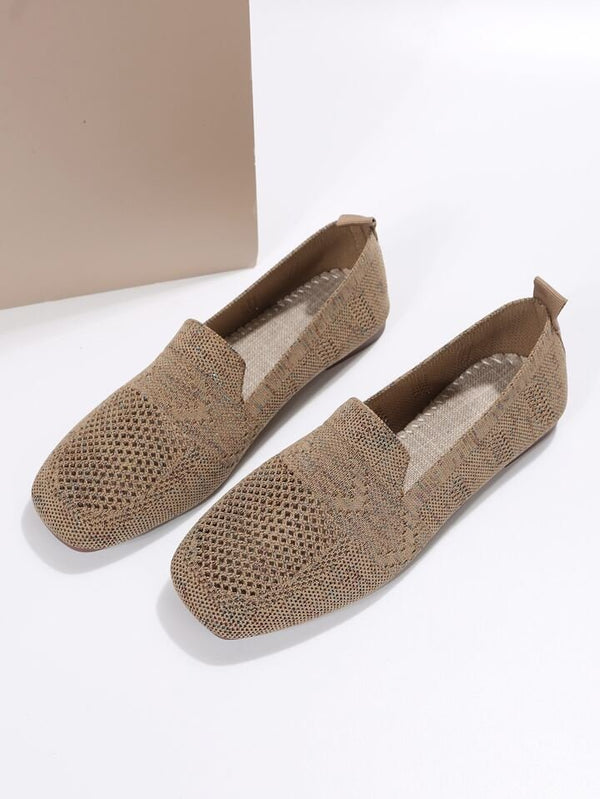 Beige woven slip-on loafers with textured design, featuring breathable material and flat soles, ideal for casual wear and comfort.