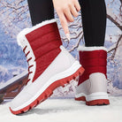 Red and white winter snow boots with fur lining, non-slip soles, and lace-up design, perfect for cold weather. Ideal for outdoor activities.