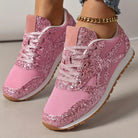 Pink glitter sneakers with mesh fabric, white soles, and gum rubber outsoles. Stylish women's footwear, perfect for casual wear and fashion trends.