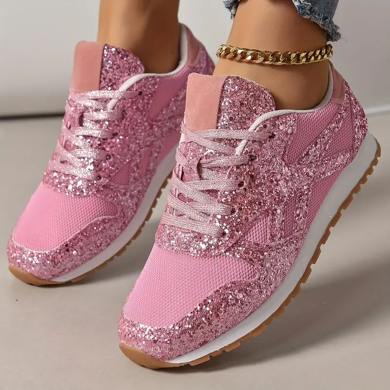 Pink glitter sneakers with mesh fabric, white soles, and gum rubber outsoles. Stylish women's footwear, perfect for casual wear and fashion trends.