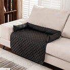 Black quilted sofa armrest cover on beige couch, featuring diamond pattern design, ideal for furniture protection and home decor enhancement.