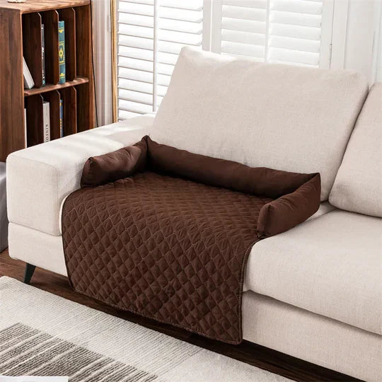 Brown quilted sofa armrest cover on beige couch, featuring protective design for furniture, ideal for pet owners and home decor enthusiasts.