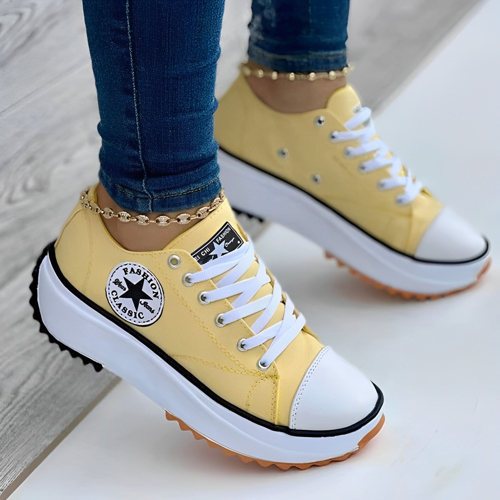 Yellow platform sneakers with white laces and black trim, featuring a star logo. Stylish casual footwear for women, perfect for fashion-forward looks.