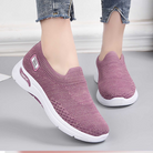 Women's pink slip-on sneakers with breathable knit upper and white sole, perfect for casual wear. Comfortable walking shoes, stylish and lightweight.