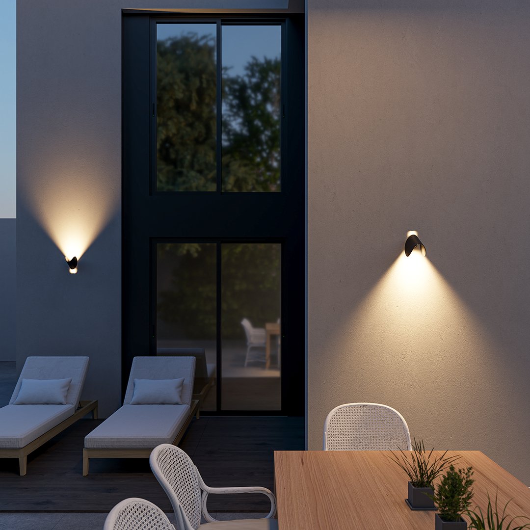 Modern outdoor patio with sleek wall lights, wooden table, white chairs, and lounge chairs. Evening ambiance, minimalist design, contemporary decor.