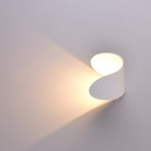 Modern white wall sconce with minimalist design, casting soft ambient light. Ideal for contemporary home decor and interior lighting solutions.