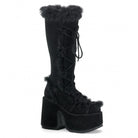 Black platform boots with fur trim and lace-up design, featuring a chunky heel. Stylish winter footwear for women. Fashionable and trendy boots.