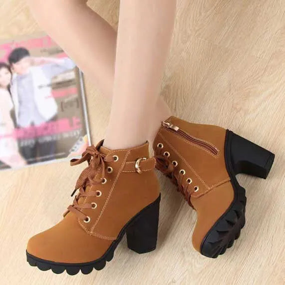 Women's brown leather platform ankle boots with chunky heels and lace-up design, featuring side zipper. Stylish, comfortable footwear for fall fashion.