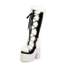 Black and white platform boot with faux fur trim and pom-poms, featuring high chunky heel and lace-up design. Fashionable winter footwear.