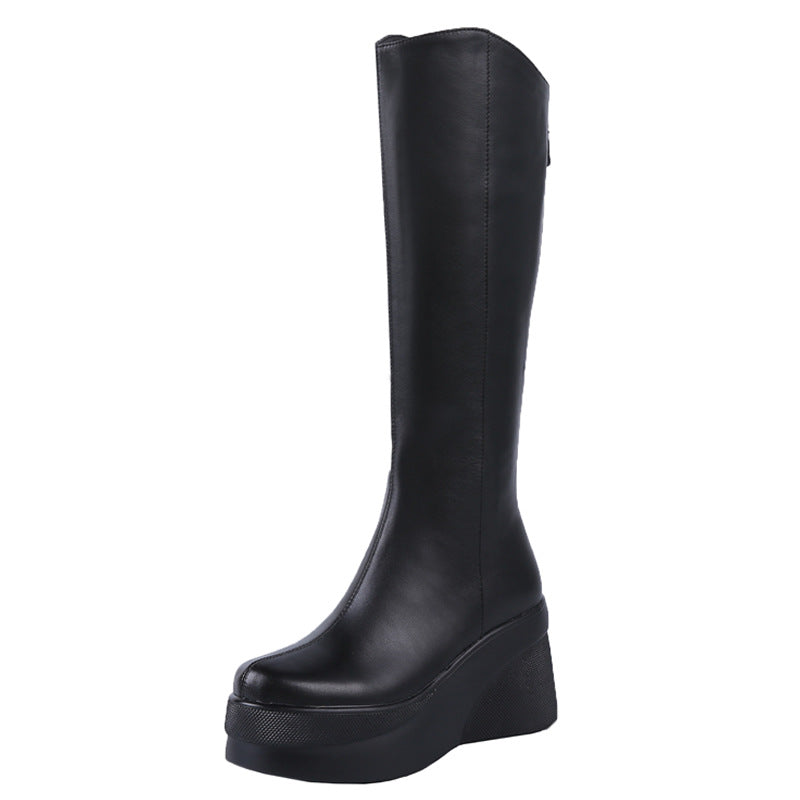 Black knee-high platform boot with chunky heel, sleek leather finish, and modern design. Perfect for fashion-forward footwear enthusiasts.