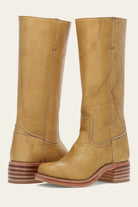 Tan leather mid-calf boots with stacked wooden heel, featuring detailed stitching. Stylish women's footwear, perfect for casual and formal wear.