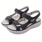 Black orthopedic sandals with adjustable straps, cushioned sole, and ergonomic design for comfort and support. Ideal for walking and casual wear.