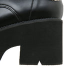 Close-up of a black leather boot with a chunky heel, featuring detailed stitching and a sleek design. Perfect for fashion-forward footwear enthusiasts.