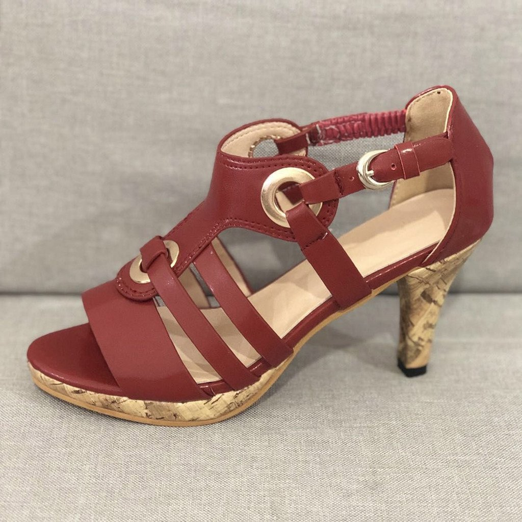 Red strappy high heel sandal with cork heel, featuring circular buckle accents, perfect for summer fashion. Women's footwear, stylish and elegant design.