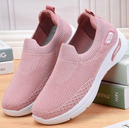 Pink slip-on sneakers with breathable mesh upper and white sole, perfect for casual wear. Lightweight, comfortable shoes ideal for walking and everyday use.