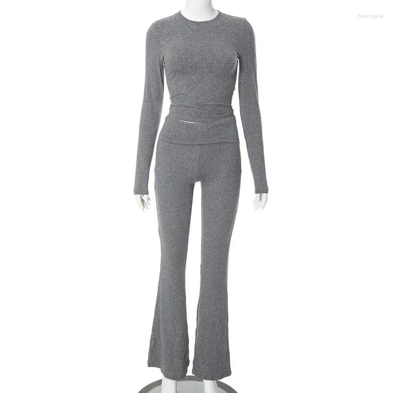 Gray long-sleeve knit jumpsuit with flared pants on mannequin, showcasing trendy women's fashion, comfortable fit, and stylish design.