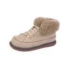 Beige suede winter boot with faux fur lining, lace-up design, and brown sole. Cozy footwear for cold weather. Women's fashion boot.