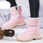 Pink winter snow boots with side zipper, rugged sole, and camouflage pattern, perfect for cold weather. Stylish women's footwear for outdoor activities.