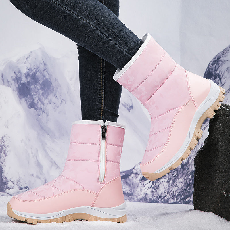 Pink winter snow boots with side zipper, rugged sole, and insulated lining, perfect for cold weather. Stylish women's footwear for snowy conditions.