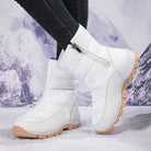 White winter snow boots with side zipper and tan rubber soles, designed for cold weather. Stylish, insulated footwear for outdoor activities.