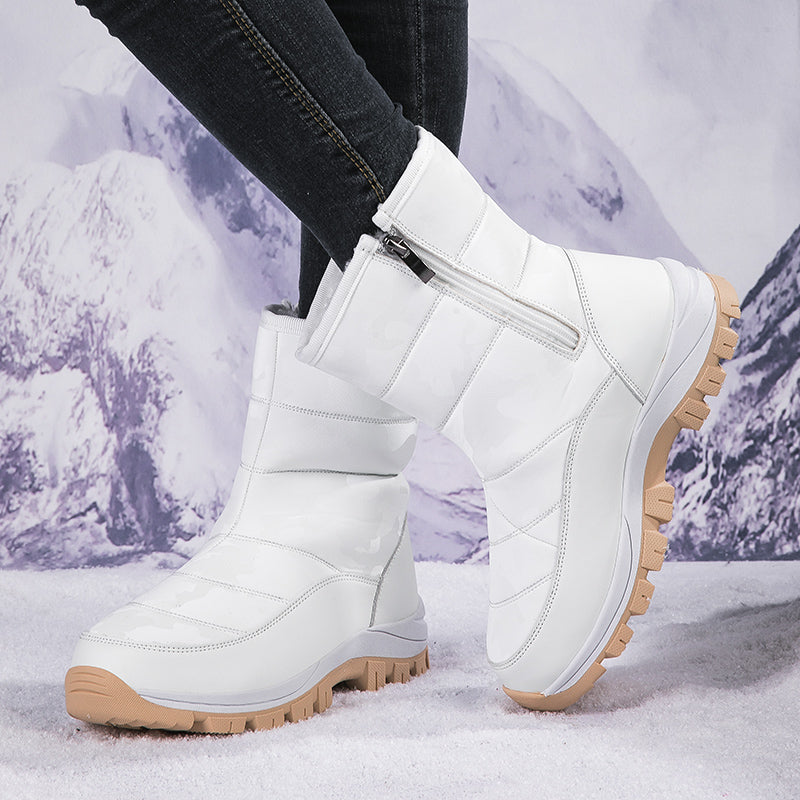 White winter snow boots with side zipper and rugged soles, perfect for cold weather. Stylish and durable footwear for snowy conditions.