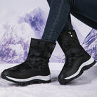 Women's black camo winter boots with side zipper, thick soles, and insulated lining, perfect for snow and outdoor activities. Stylish and durable footwear.