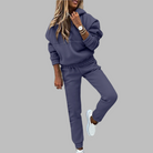 Woman in blue jogger set, casual loungewear, white sneakers, stylish outfit, comfortable fashion.