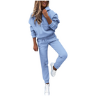 Woman in light blue hoodie and joggers set, casual loungewear, white sneakers.