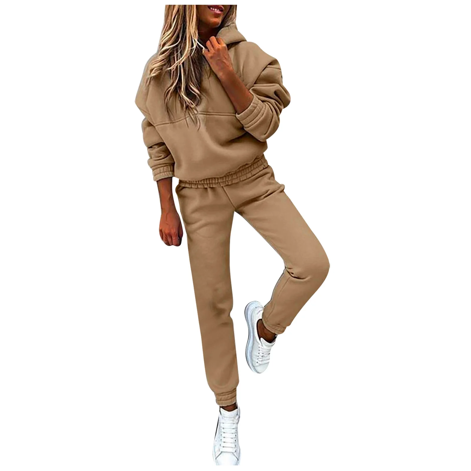 Woman in beige hoodie and joggers set with white sneakers, casual loungewear outfit.