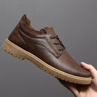 Brown leather casual shoe with lace-up design, rubber sole, and ankle-high knit collar, ideal for men's fashion and comfortable everyday wear.
