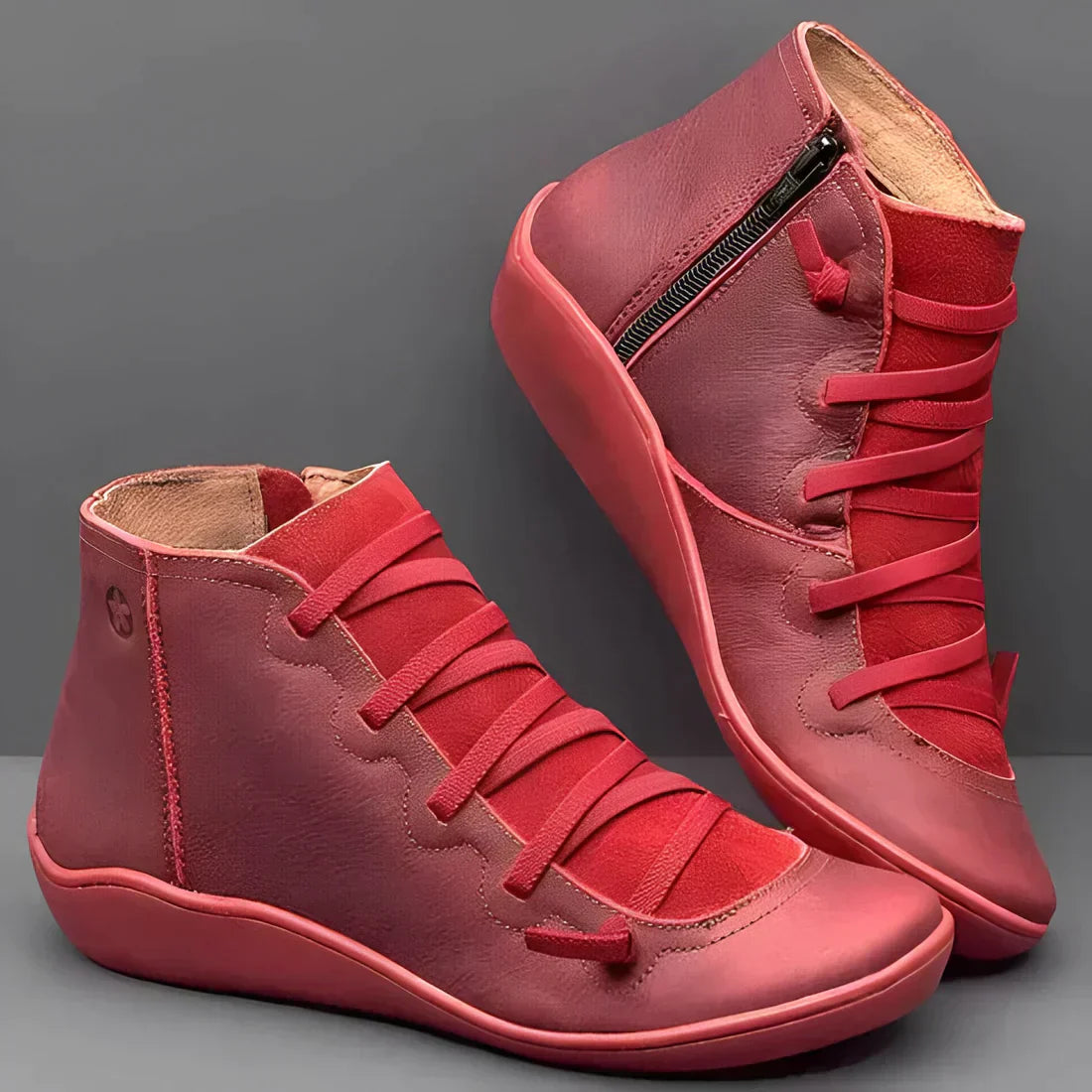 Red high-top leather sneakers with side zipper and wide laces, featuring a minimalist design. Stylish casual footwear for men and women.