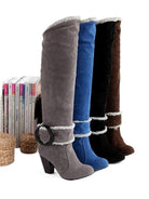 Four stylish knee-high suede boots in gray, blue, black, and brown with block heels and decorative buckles, perfect for fall fashion trends.