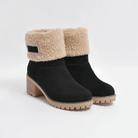 Black suede ankle boots with faux fur lining, chunky wooden heel, and lug sole. Stylish winter footwear for women, perfect for cold weather.