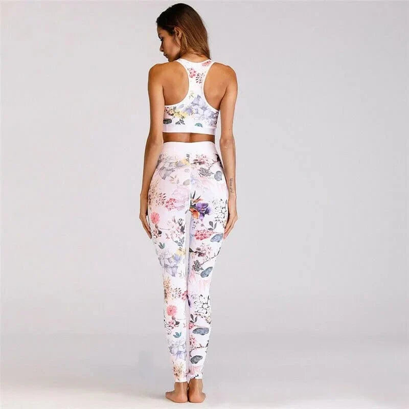 Woman wearing floral print activewear set, featuring a racerback sports bra and high-waisted leggings, perfect for yoga or gym workouts.