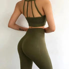 Green athletic set with decorative back stripes, featuring a sports bra and high-waisted leggings. Perfect for yoga, gym, or casual wear.