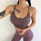 Woman in light purple sports bra and leggings set with decorative back stripes, showcasing fitness fashion. Ideal for yoga, gym, activewear enthusiasts.