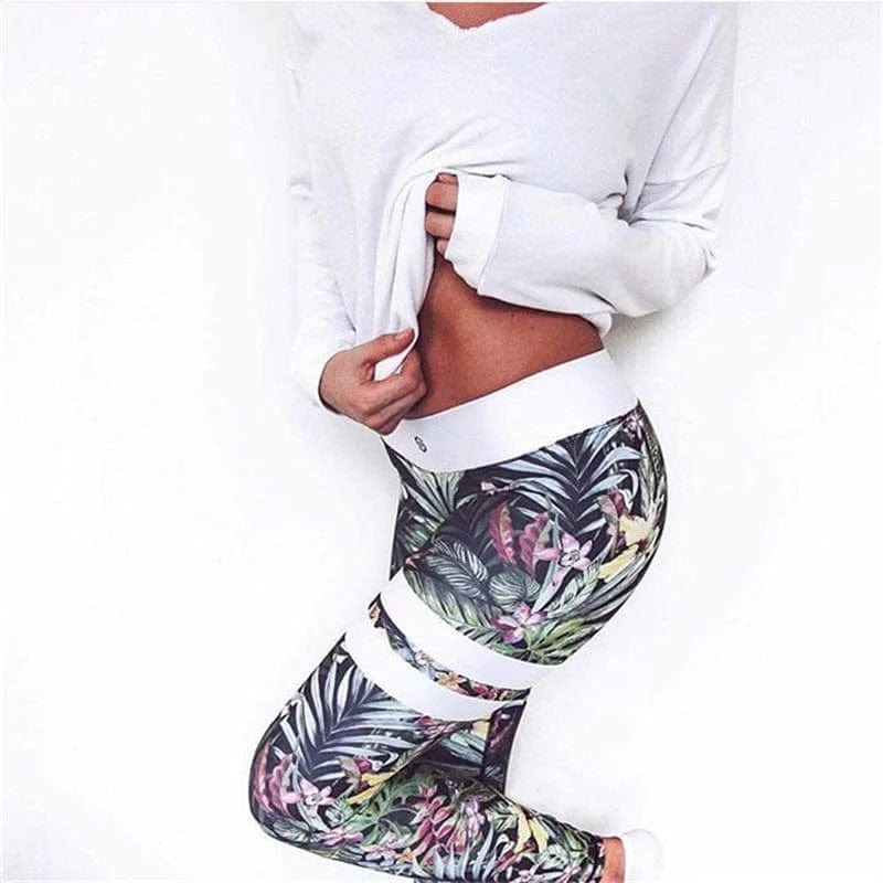 Woman wearing floral patterned leggings and a white long-sleeve top, showcasing stylish activewear. Fashionable workout outfit, floral sportswear.