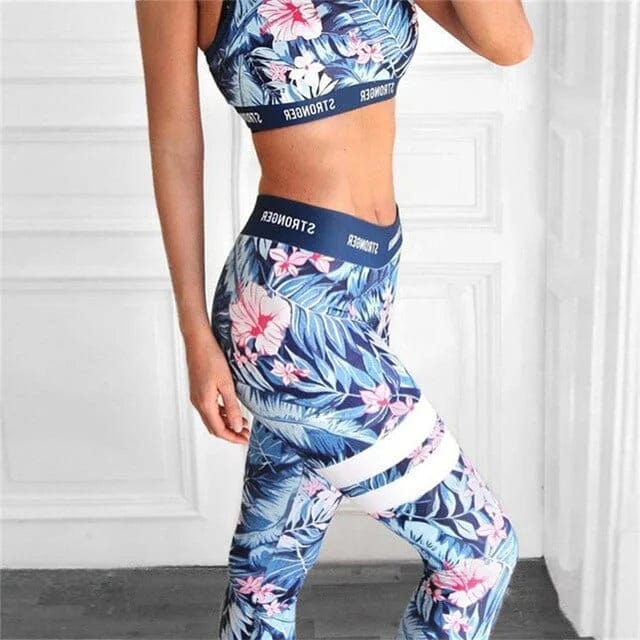 Women's blue floral sports set, featuring a crop top and leggings with tropical patterns. Perfect for yoga, gym, or activewear fashion.