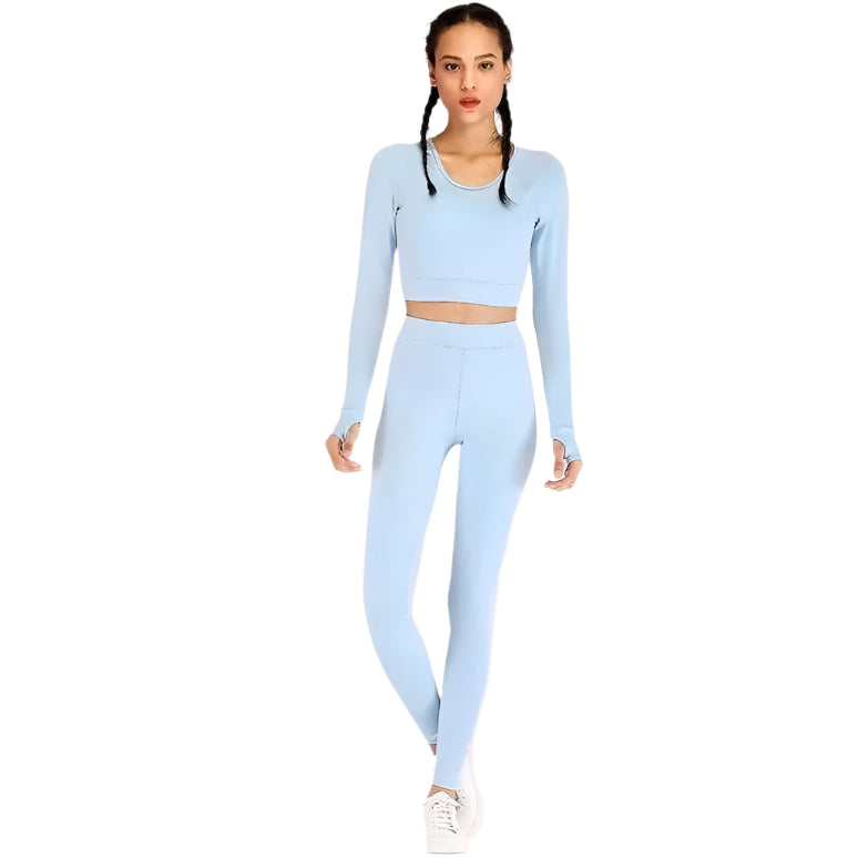 Woman in light blue long-sleeve crop top and leggings set, showcasing activewear fashion. Perfect for yoga, gym, or casual wear. Comfortable and stylish.