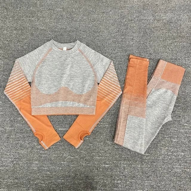 Ombre effect sports set with long-sleeve crop top and leggings in gray and orange, perfect for yoga or gym workouts. Stylish activewear outfit.