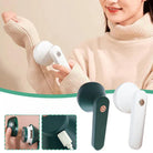 Electric fabric shaver in white and green, featuring a power button, USB charging port, and detachable lint container, ideal for sweater maintenance.