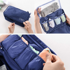 Travel packing cube organizer in blue, featuring multiple compartments for efficient storage of socks and underwear. Ideal for luggage organization.