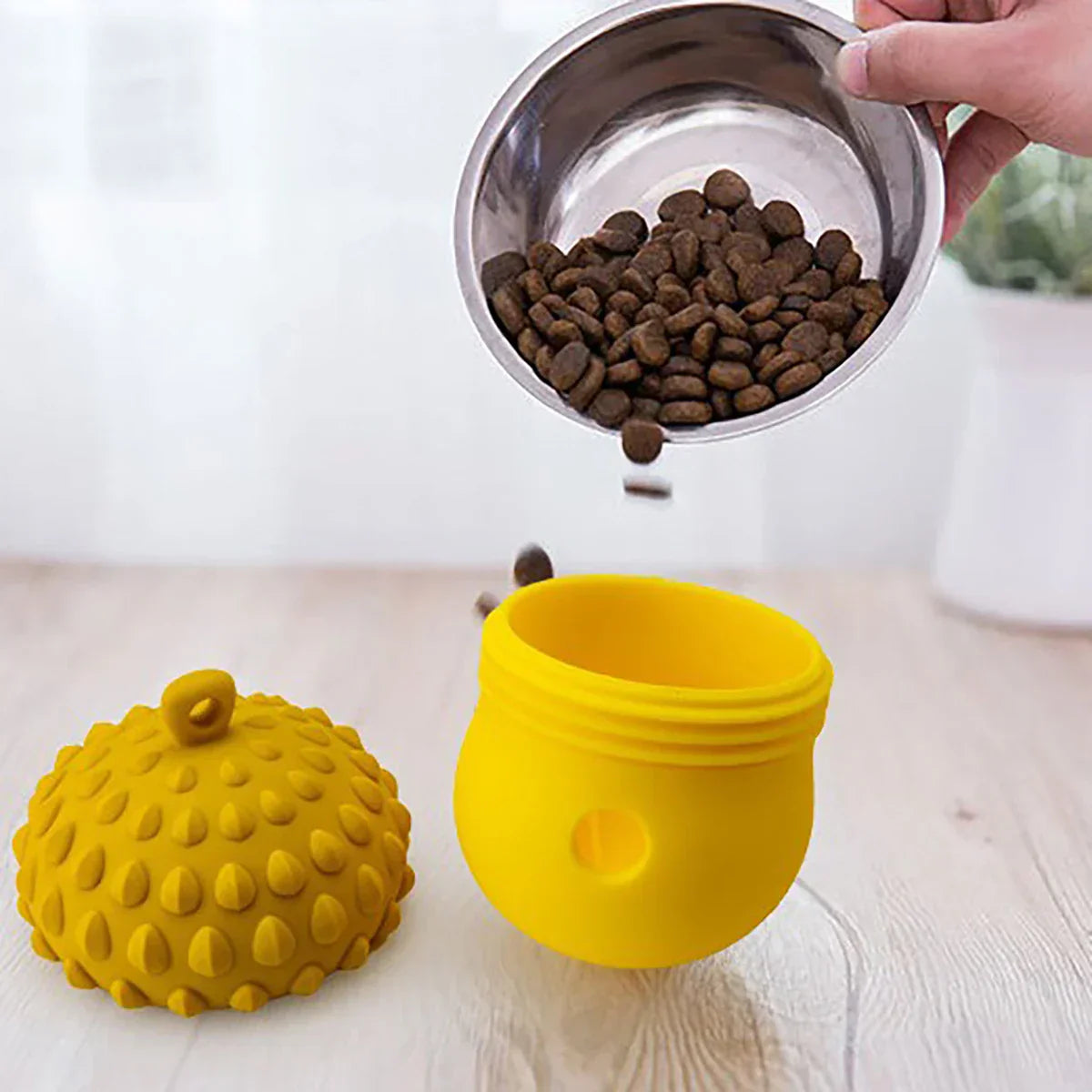 Yellow interactive dog toy with textured lid, designed for dispensing treats or kibble. Ideal for pet enrichment and mental stimulation.