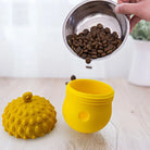 Yellow interactive dog toy with textured lid, designed for dispensing treats or kibble. Ideal for pet enrichment and mental stimulation.