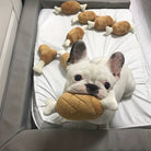 French Bulldog playing with plush bone toys in a cozy dog bed. Cute puppy surrounded by stuffed animal bones, perfect for pet lovers and dog toy enthusiasts.