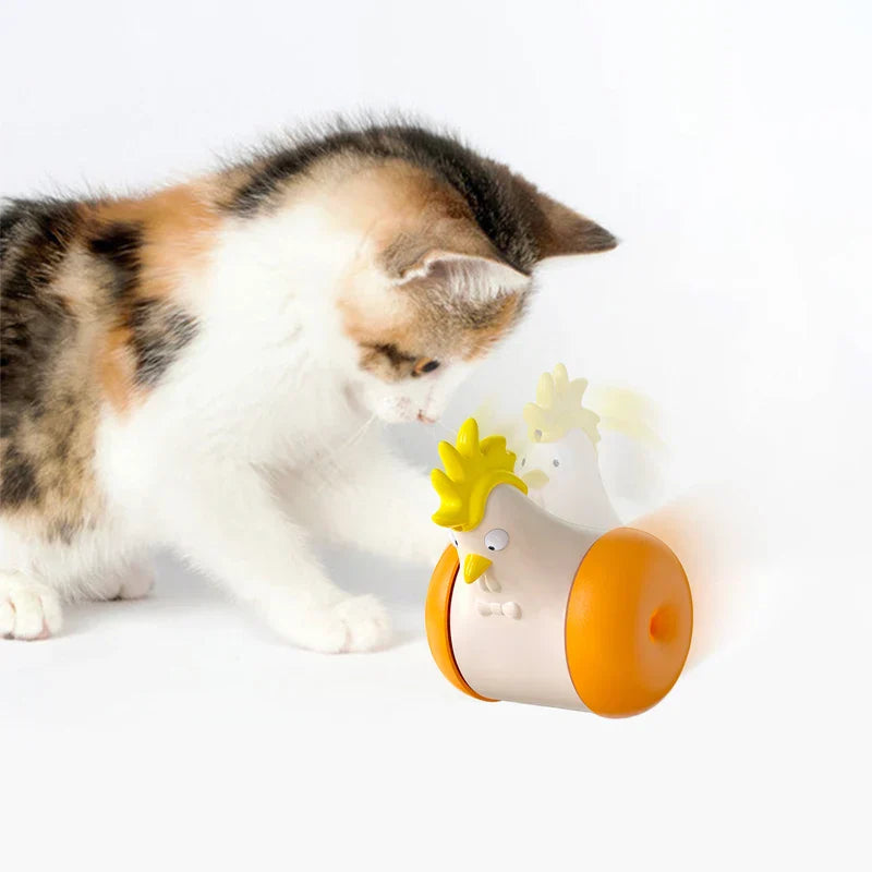 Calico kitten playing with interactive chicken-shaped cat toy; pet entertainment, feline enrichment, playful kitten, cat toy with wheels.