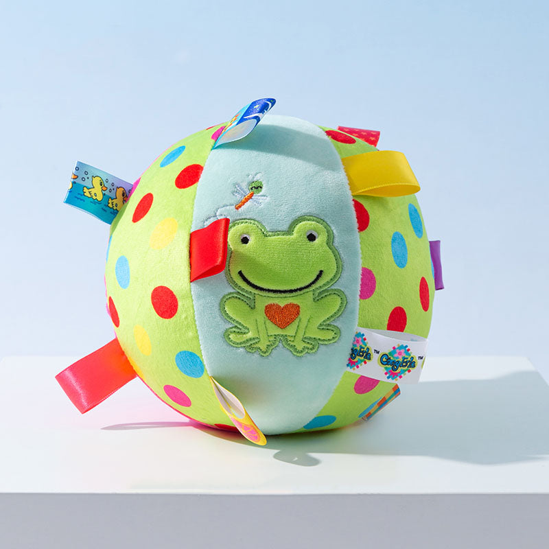 Colorful polka dot baby ball with frog design and ribbon tags, perfect for sensory play and infant development. Soft, plush toy for toddlers.