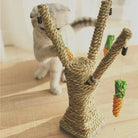 Cat playing with a woven sisal rope scratching post featuring dangling carrot toys, perfect for feline entertainment and claw maintenance.