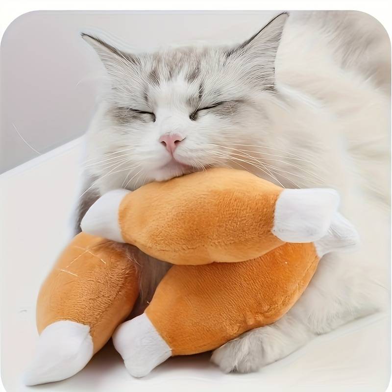 Fluffy white cat cuddling plush drumstick toys, cute pet photo, adorable feline with soft fur, cozy and relaxed, perfect for cat lovers.